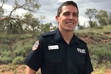 A close up photo of Constable Zachary Rolfe smiling while he stands outside in Alice Springs.