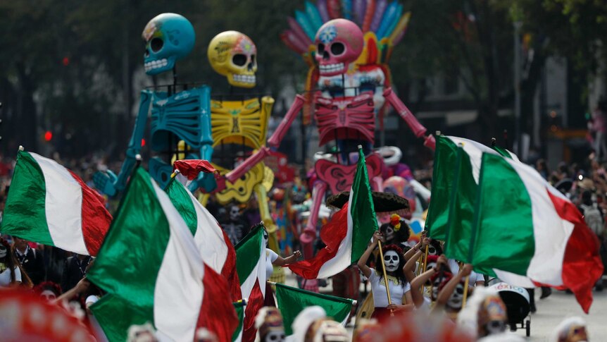 Performers held the Mexican flag high alongside colourful puppets and figurines.