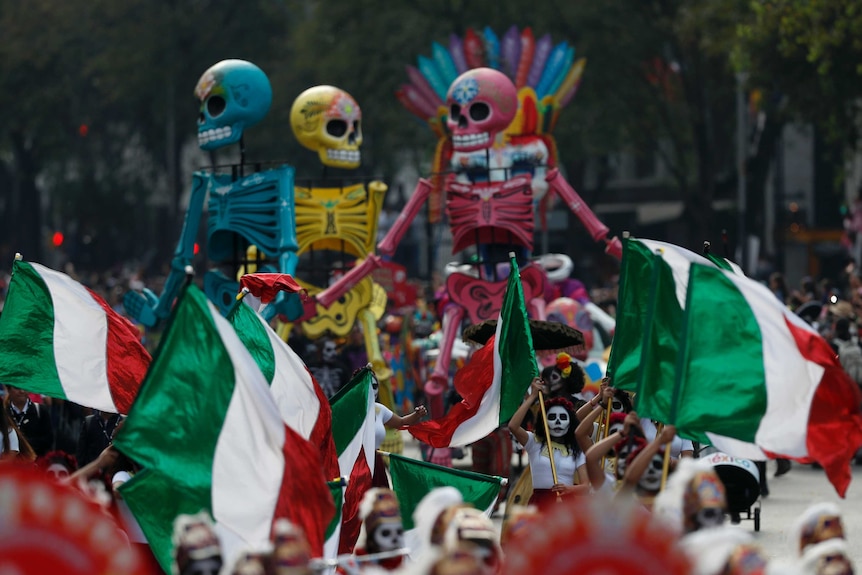 Performers held the Mexican flag high alongside colourful puppets and figurines.