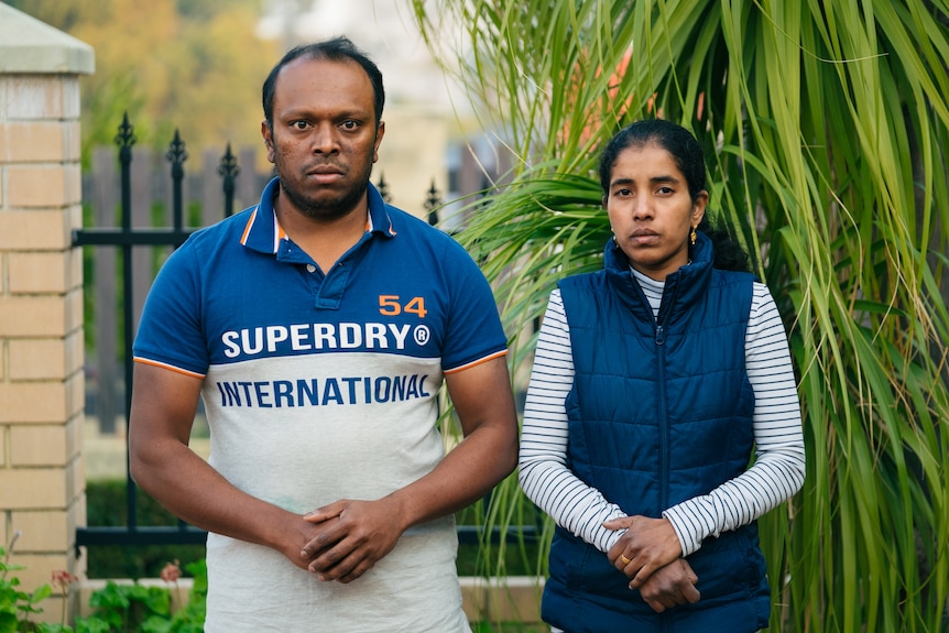 Aswath Chavittupara and Prasitha Sasidharan standing next to each other in their front yard, with their hands clasped in front.