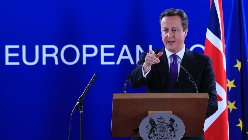 British PM David Cameron speaks in front of UK and EU flags