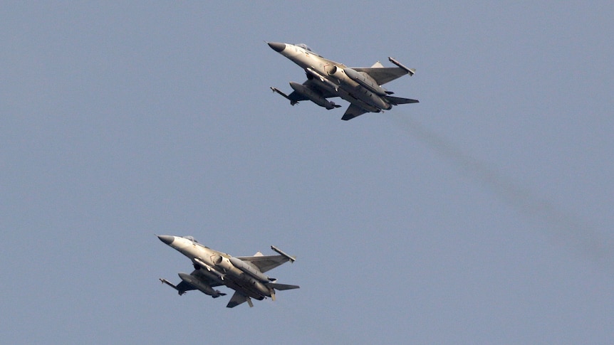 Two Taiwan Air Force fighter jets streak across the sky during a military drill in Taiwan, May 15, 2013.
