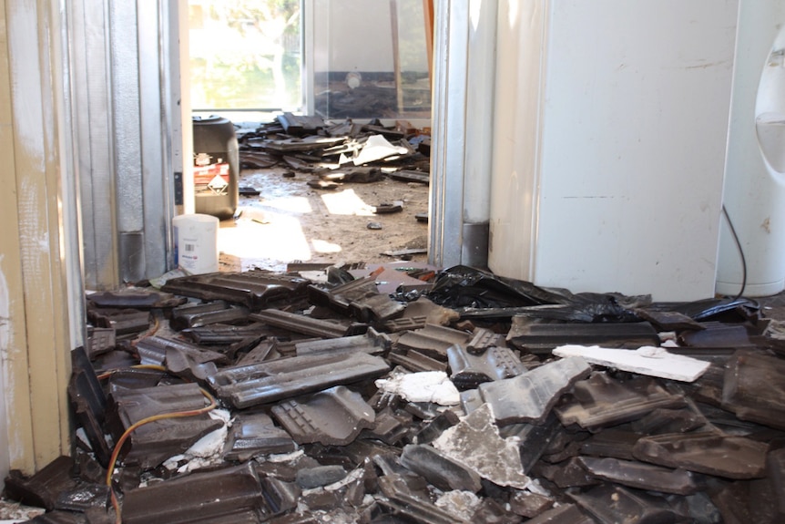 Shattered roof tiles litter the upper-storey of a house in Osborne Park