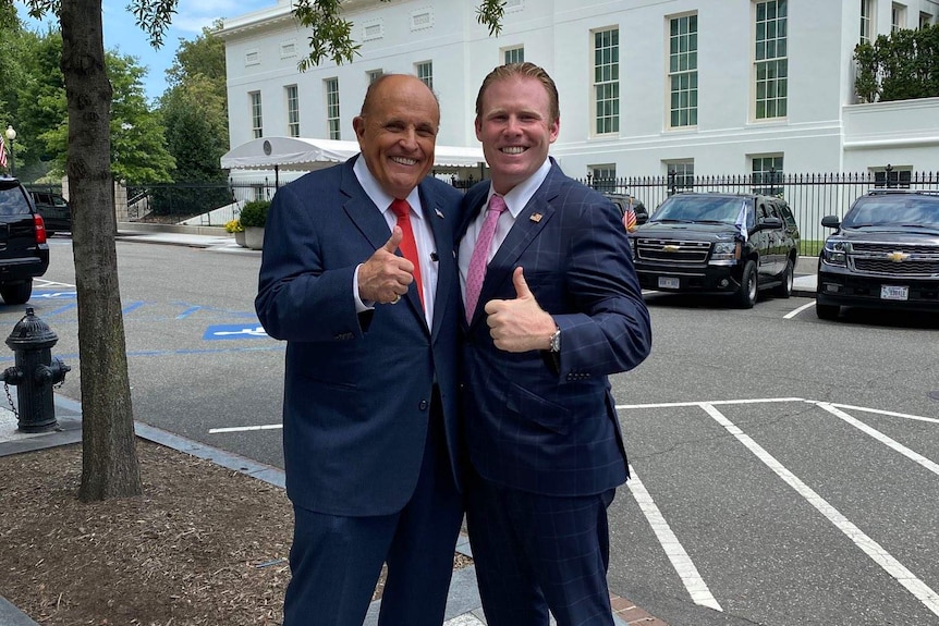Rudy Giuliani and his son Andrew smile and give a thumbs up together