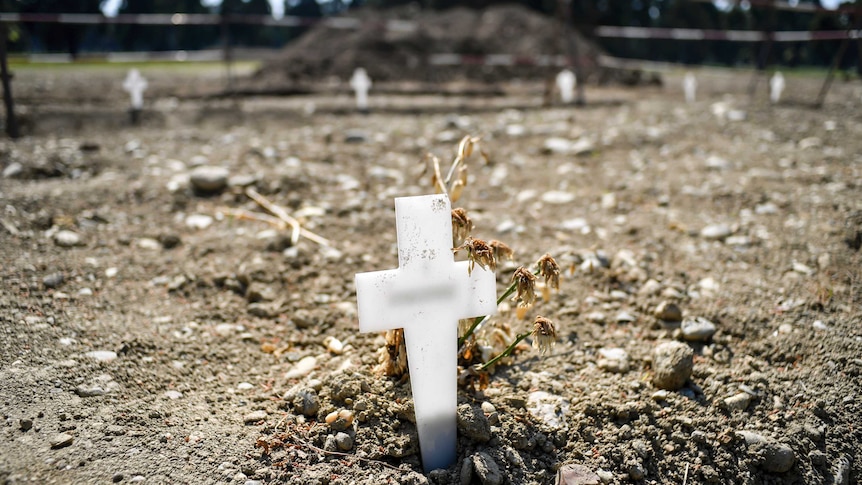 A cross in a cemetary marking a grave