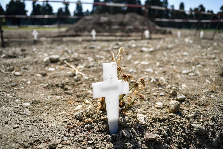 A cross in a cemetary marking a grave