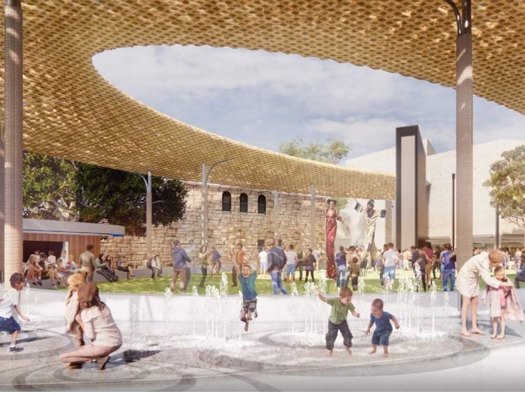 Children play in fountains underneath a circular arbour