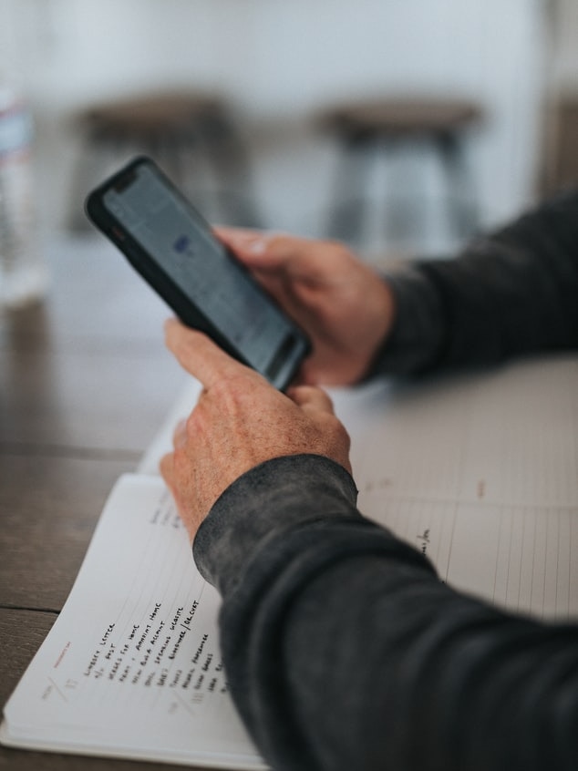 An unidentified man using his phone.