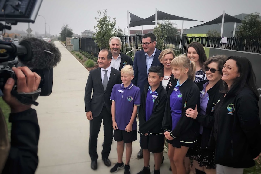 The Premier and Education Minister pose for a photo with primary school students.