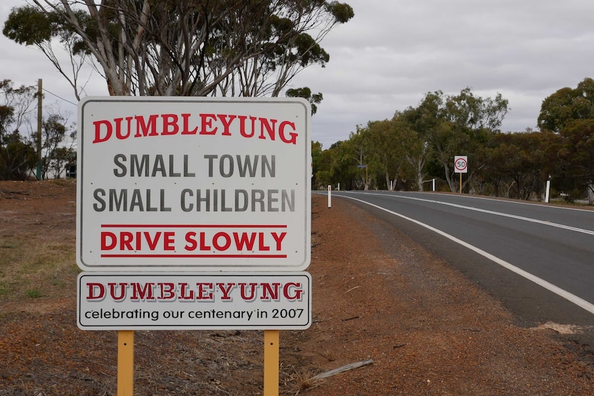 A road sign in Dumbleyung which says "Small town, small children, drive slowly"