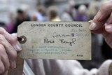 WWII evacuee displays luggage tag