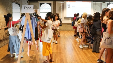 Image of clothing swap event with words 'War on Waste Clothes Swap and Style'