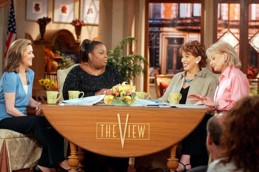 Barbara Walters (far right) sits at the desk on the panel TV show The View in 2003 with three other hosts