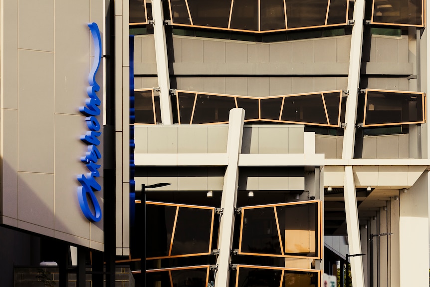 the outside of a building at Chisholm TAFE in Frankston. There is a blue Chisholm logo on the wall.