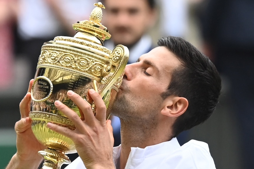 Novak Djokovic holds a trophy