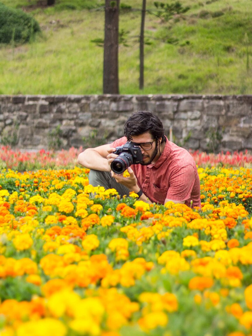 Garrett Eckerson shooting photos of flowers.