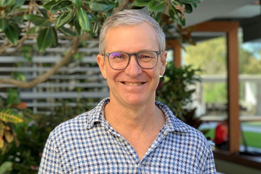 Physiotherapist Miles Browning stands in the garden of The Village Yeronga.