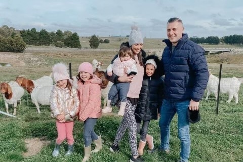 Bashir Naim and family with goats in the background