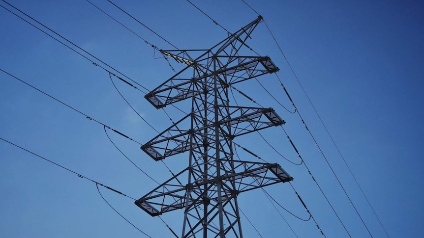 Angled close-up of high tension power lines and steel towers looking up towards a blue sky in Brisbane.