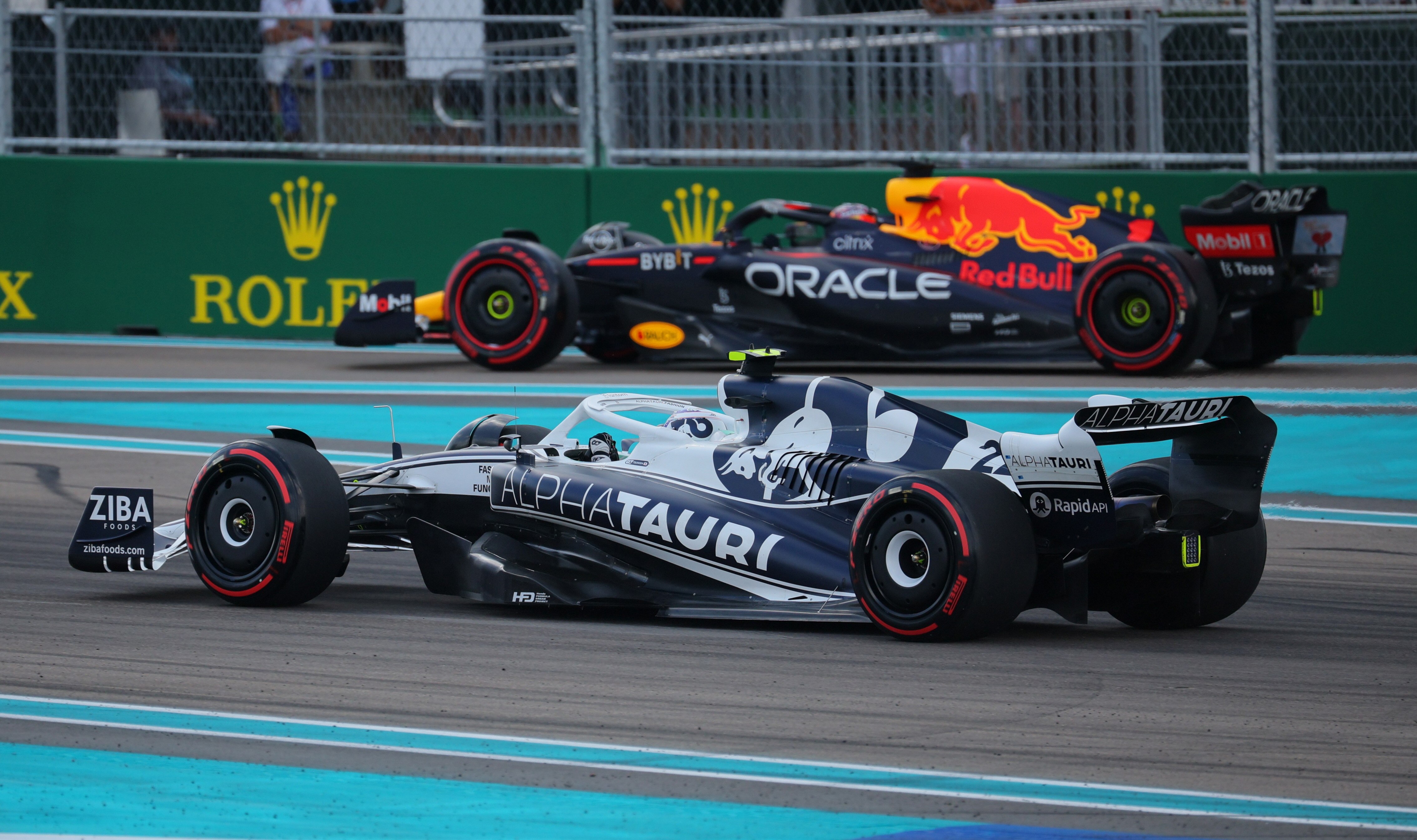 Two F1 cars on track, both bluem preparing for qualifying