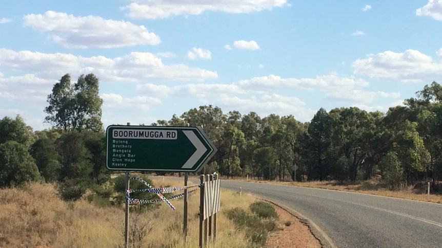 A big road sign pointing in the direction of the area where a woman is  missing in NSW bushland.