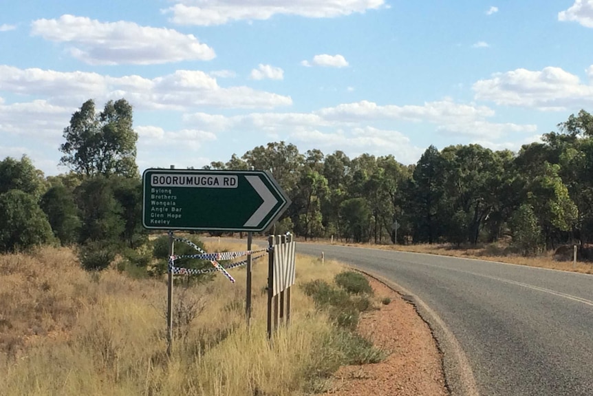 A big road sign pointing in the direction of the area where a woman is  missing in NSW bushland.
