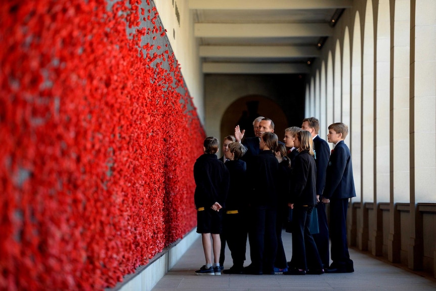 Prime Minister Tony Abbott with school children at the Australian War Memorial.