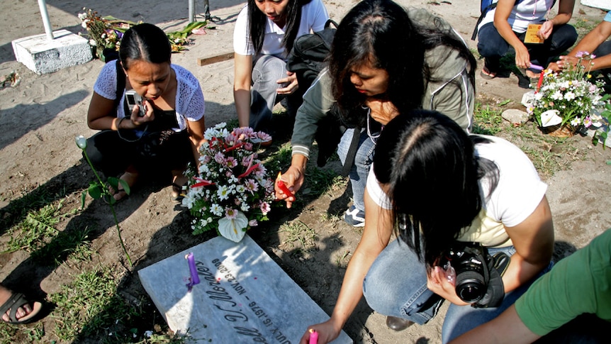 Relatives of victims light candles at Ampatuan massacre site