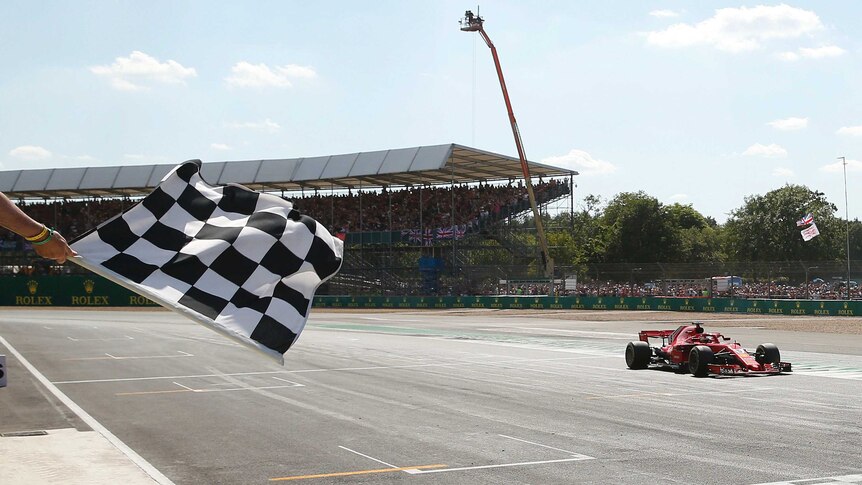 Ferrari driver Sebastian Vettel crosses the finish line to win the 2018 British F1 Grand Prix.