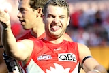 Tom Papley smiles with his tongue out as he gestures to the crowd after a win