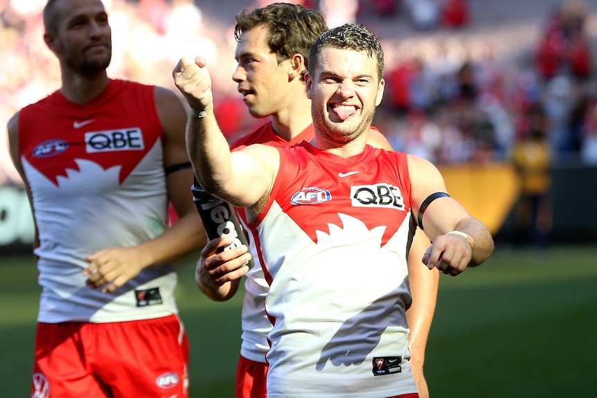 Tom Papley smiles with his tongue out as he gestures to the crowd after a win