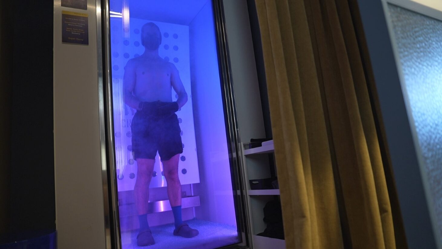 Tristan Sternson in a blue light cryo chamber