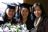 Susan (middle) poses with friends on her graduation day