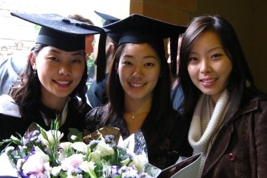 Susan (middle) poses with friends on her graduation day