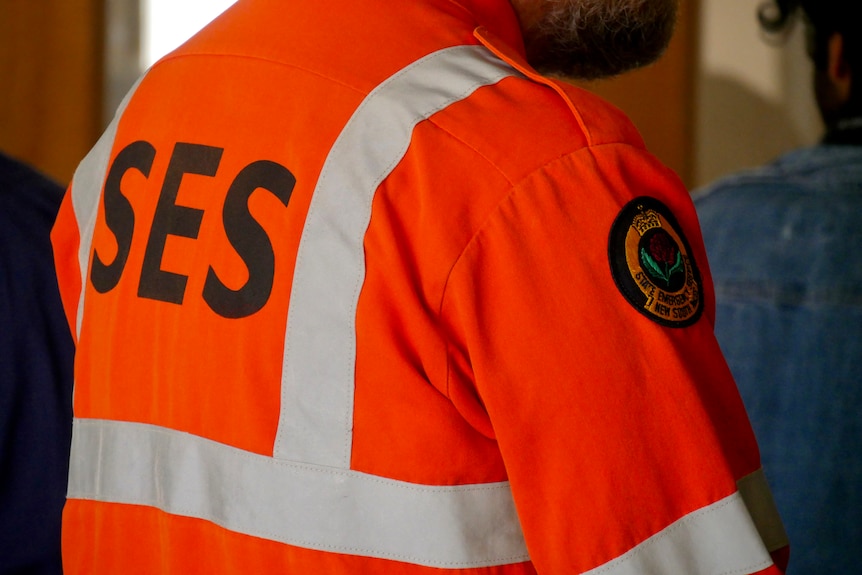 A man wearing an orange NSW State Emergency Services uniform.