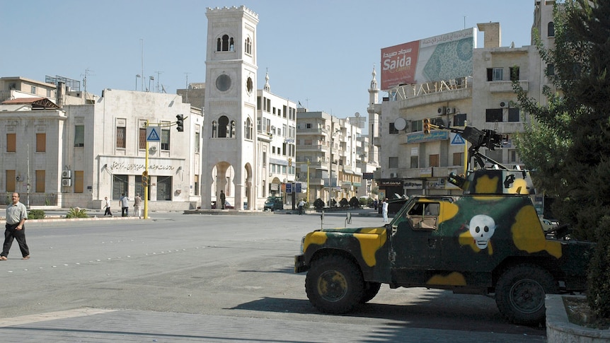An armoured military vehicle on a main street of Hama.