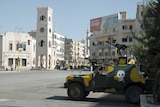 An armoured military vehicle is parked on a main street of the Syrian city of Hama on August 11, 2011.