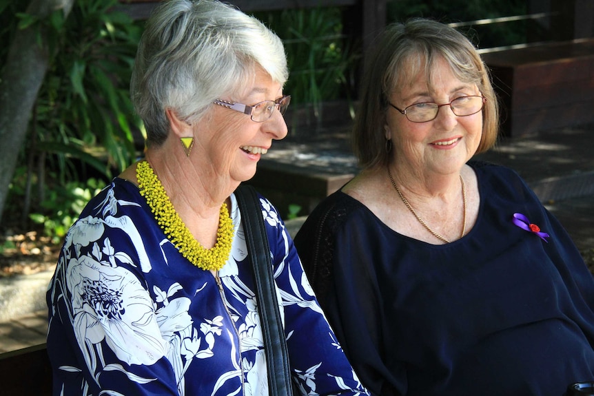 Dorelle Downs and Margaret Hamilton, in their mid 60s, chat on a park bench.