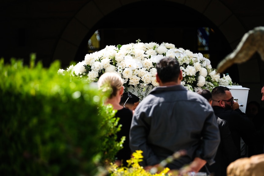 A coffin with flowers 