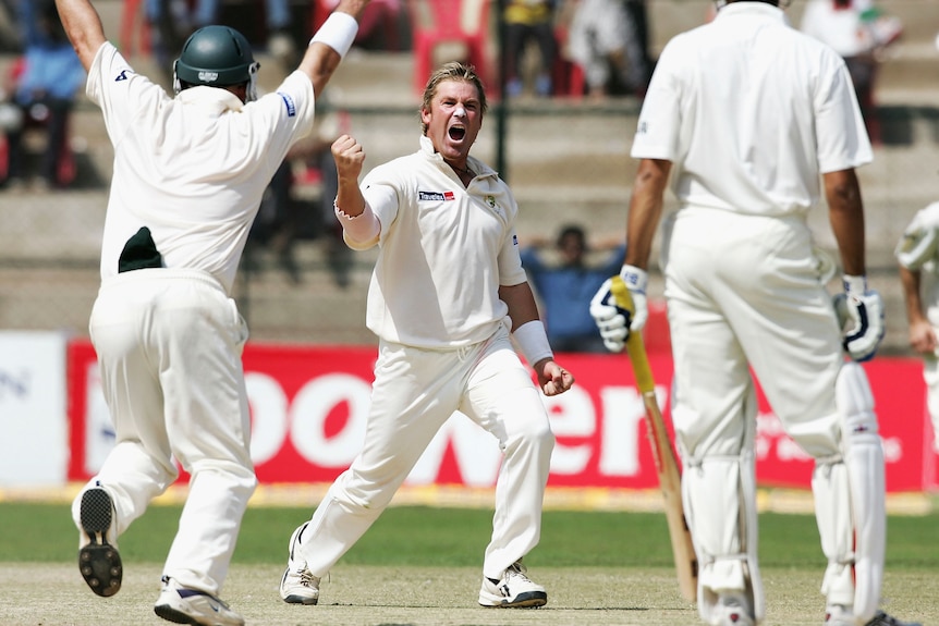 Shane Warne clenches his fist and opens his mouth looking at a batter