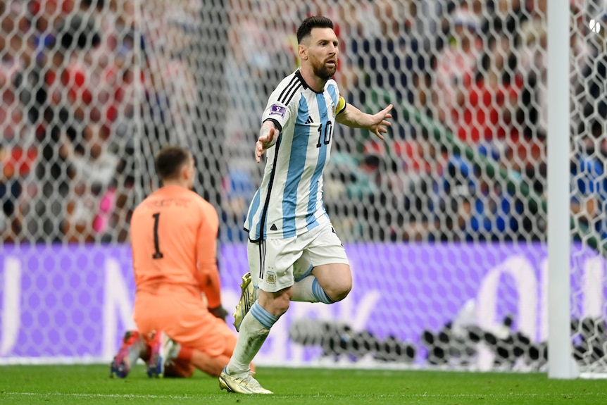 Argentina's Lionel Messi runs away with arms outstretched after scoring a goal against Croatia in the FIFA World Cup semifinal.