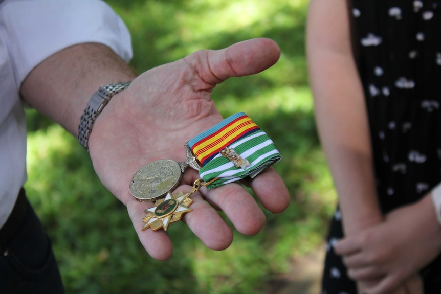 Close up of two medals with new ribbons.