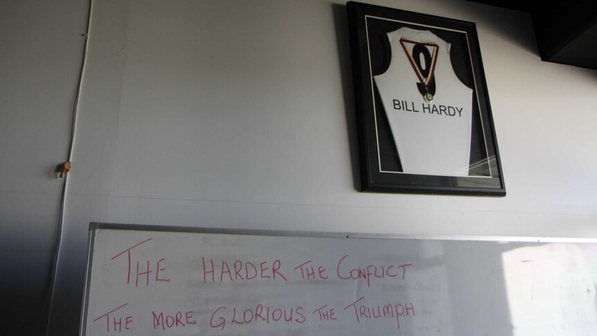 Billy Hardy's AFL jersey in a frame in the Southport Sharks locker room