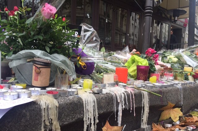 Growing pile of flowers and candles outside a restaurant where bullets were randomly sprayed during Paris attacks.