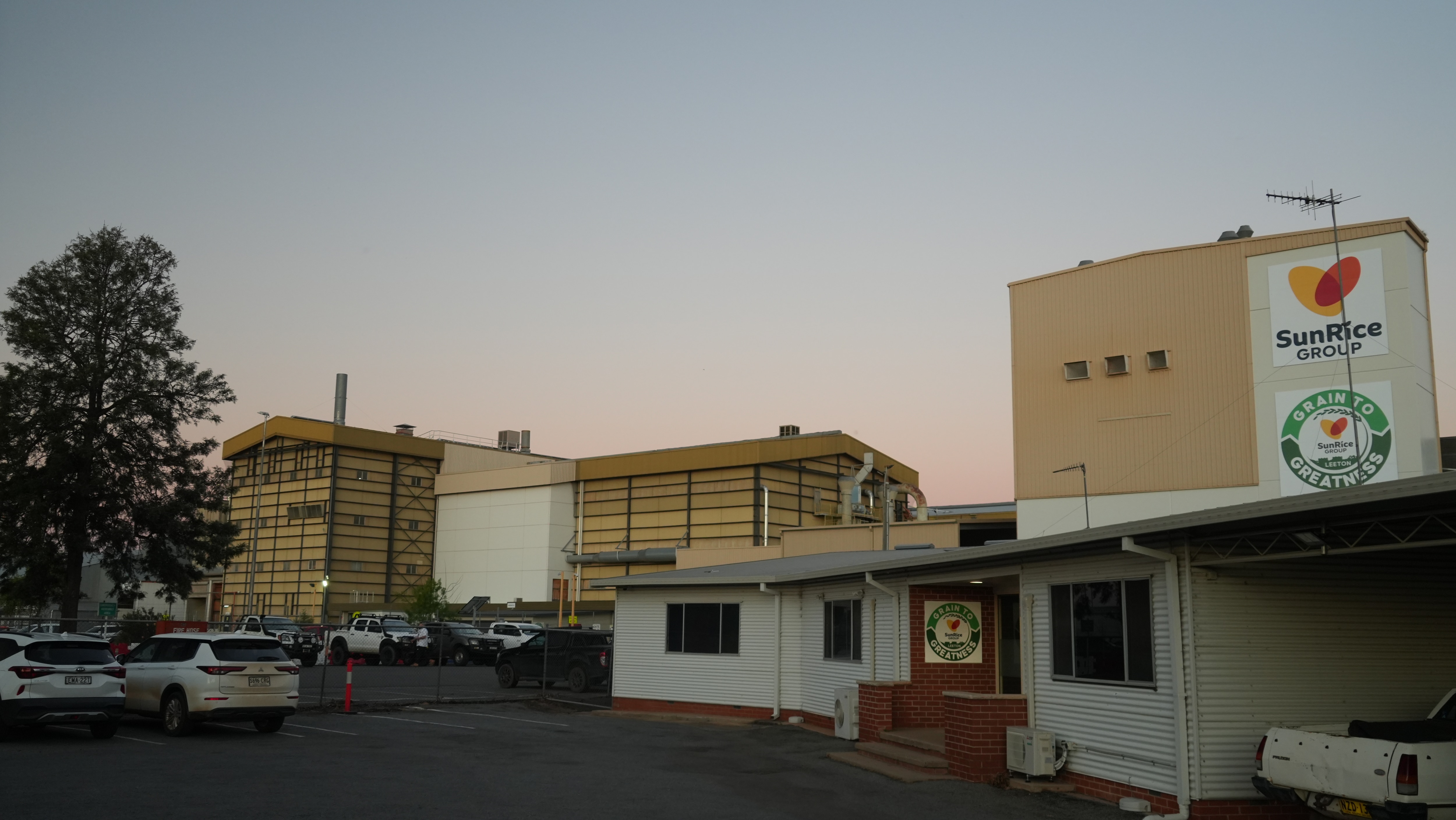 Industrial buildings with a sign saying SunRice on one