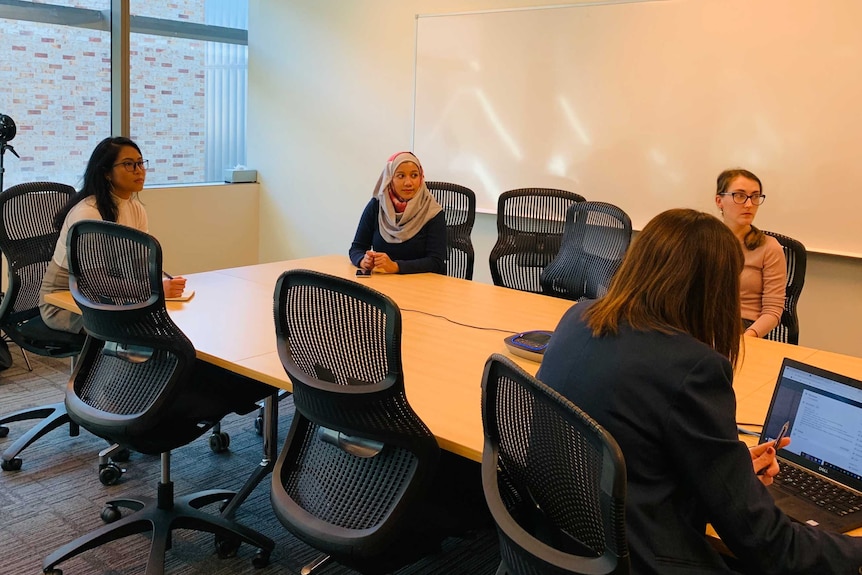 A group of women in a meeting room.