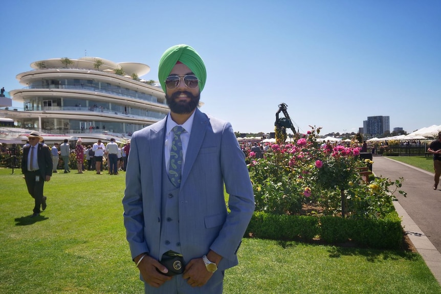 A man stands trackside at the Melbourne Cup. 