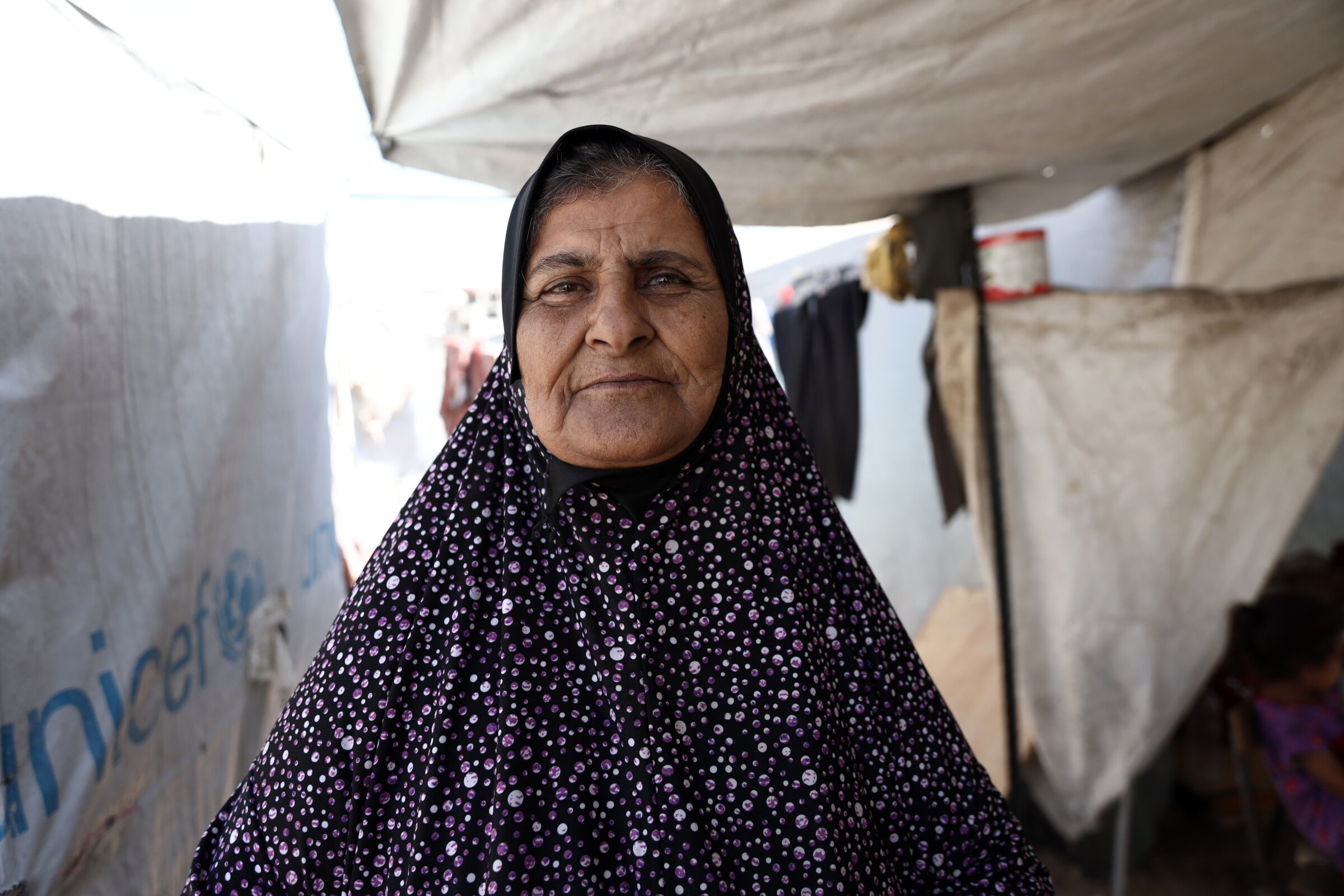 A photo of Samira Abu Odeh. She has brown eyes and is wearing a hijab with a flower pattern. 