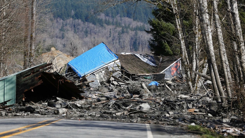 Landslide and structural debris blocks Highway 530 near Oso, Washington.