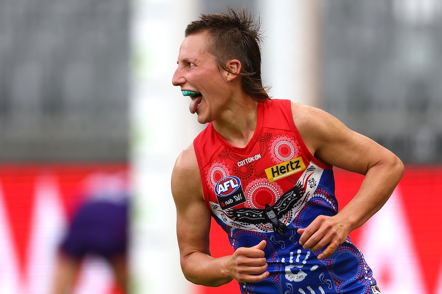 Melbourne AFLW player Karen Paxman pokes out her tongue after kicking a goal